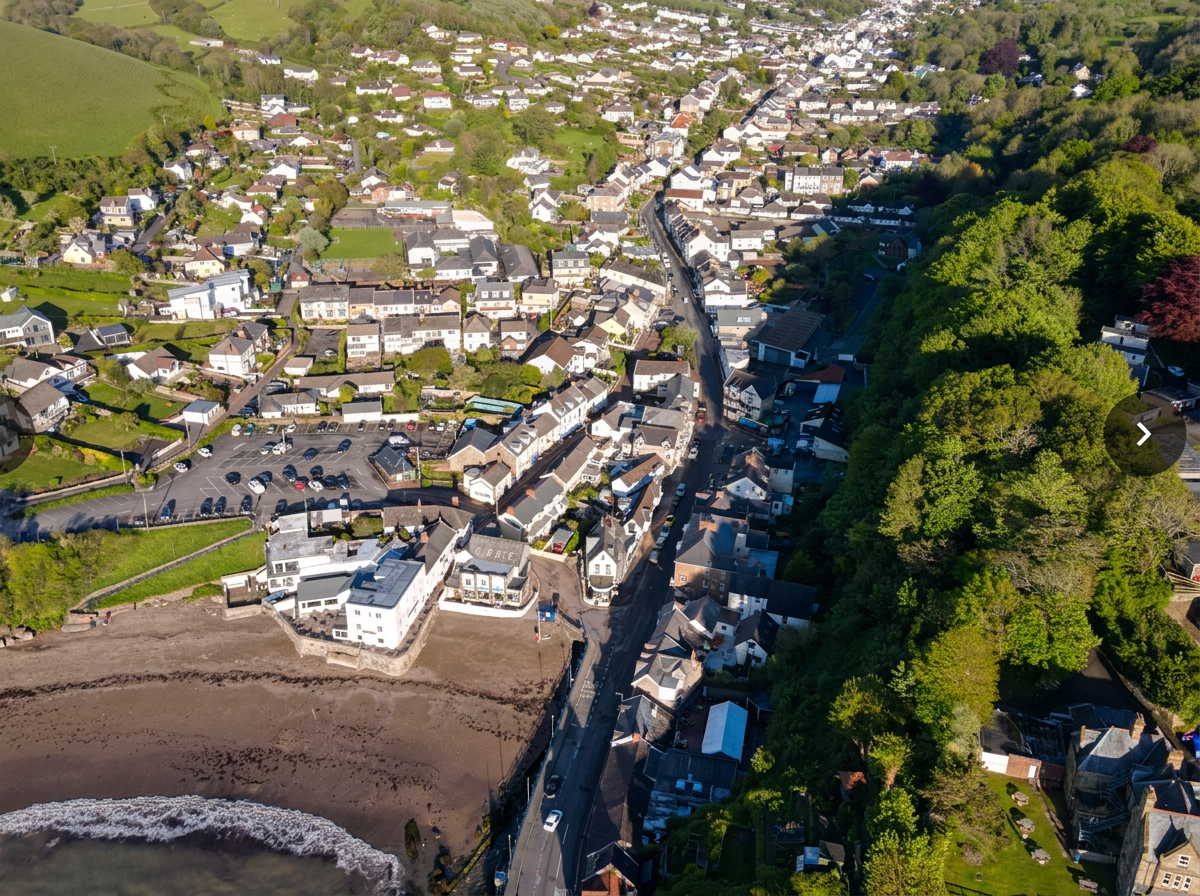 Aerial view of Combe Martin village extending inland from the beach